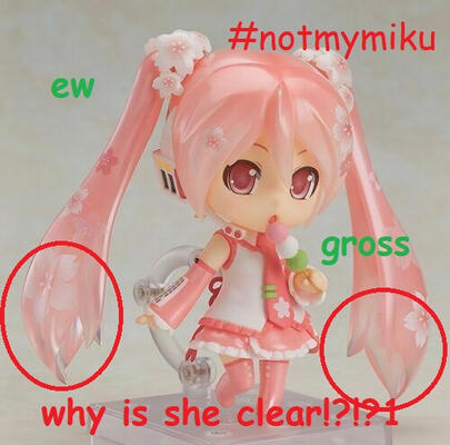 A Sakura Miku Nendoroid #500 with the text "#notmymiku", "ew", and "gross" in comic sans surrounding her. The ends of her pigtails are circled in red, with the text "why is she clear!?!?1" in comic sans below her.